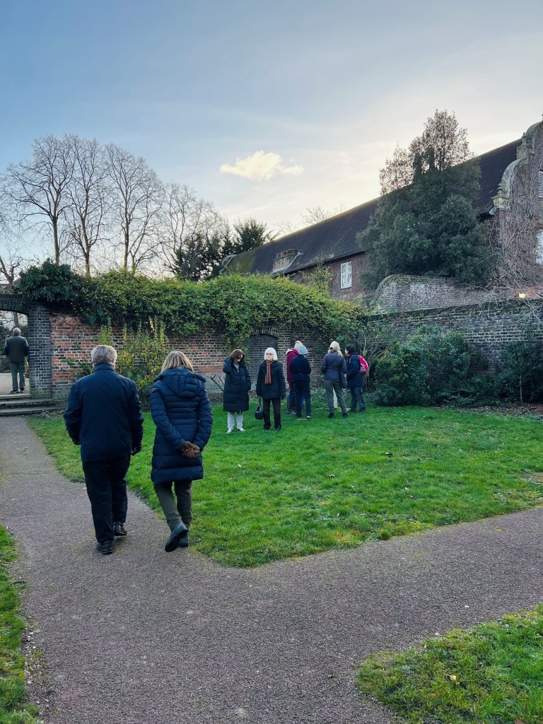 Group of volunteers wandering gardens to spot for flowers