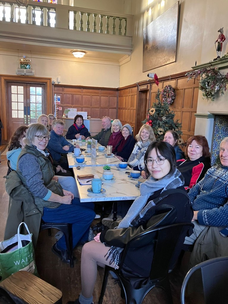 Group of volunteers having coffee and discussing the flowers found on their  winter wander