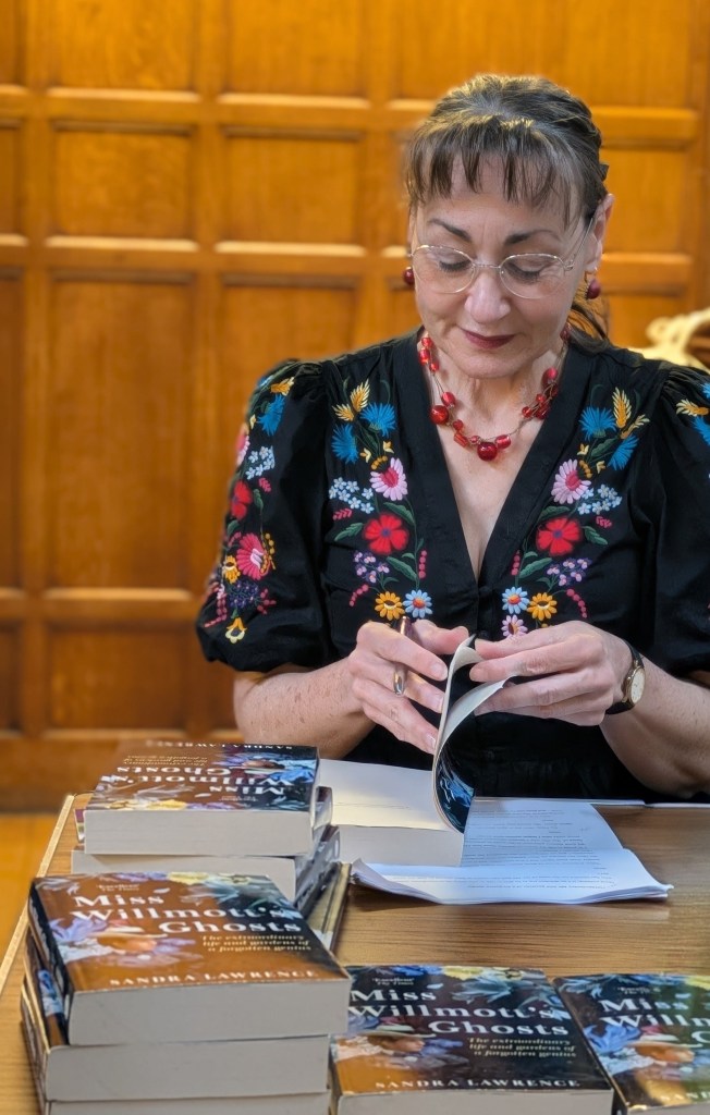 Sandra Lawrence signing copies of her books on Ellen Willmott. CABAHS May 2026