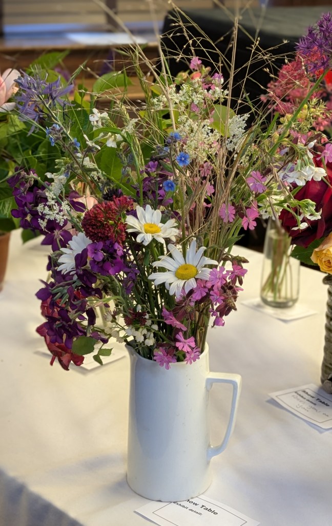 A lovely, naturalistic arrangement of flowers on the Show Table, May 2026