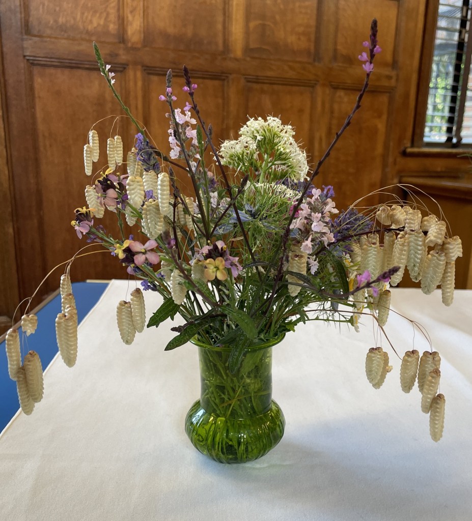 A delicate arrangement of flowers and grasses on the Show Table, June 2026