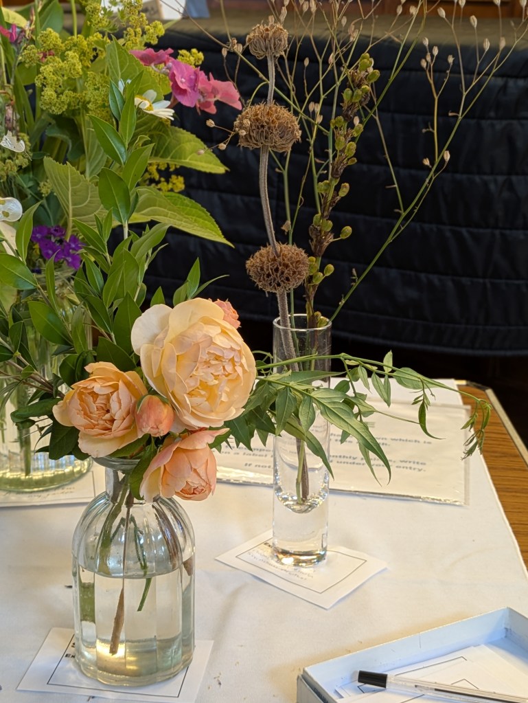 Roses and seedheads on the Show Table, July 2026