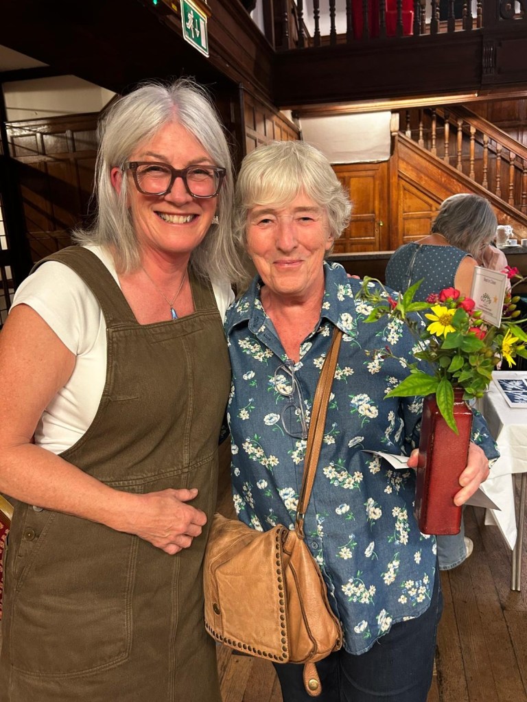 Helena, Best in Class 2 (Bowl or vase of mixed flowers), congratulated by judge Susan Urpeth CABAHS Autumn Show 2026